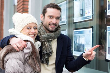 View of a Young attractive couple in front of an agencyの写真素材