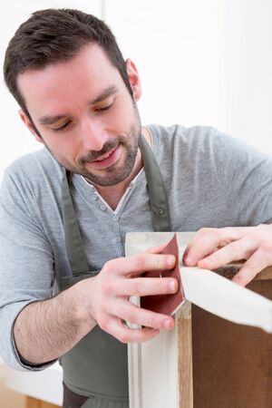View of a Young attractive carpenter working in his workshopの写真素材