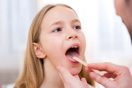 View of a Young little girl being examinated by a doctor