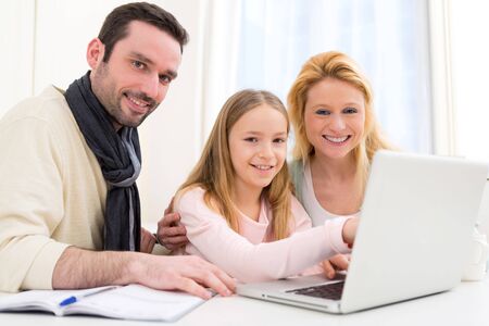 View of a Happy family in front of a laptopの写真素材