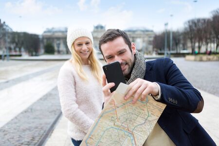 View of a Young couple on holidays taking pictures in the cityの写真素材
