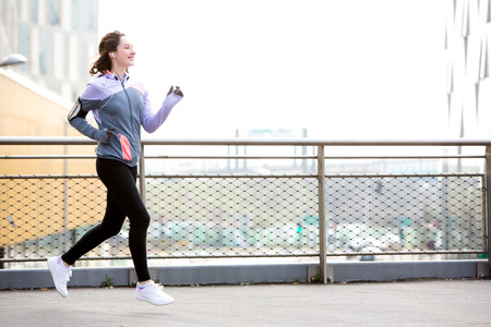 View of a Young attractive woman running downtown