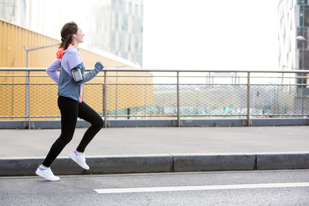 View of a Young attractive woman running downtownの写真素材