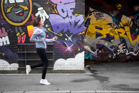 View of a Young attractive woman running downtownの写真素材