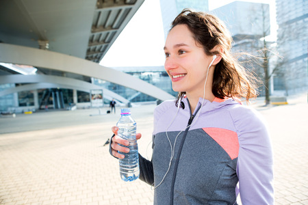 View of a Woman drinking water during a running sessionの写真素材