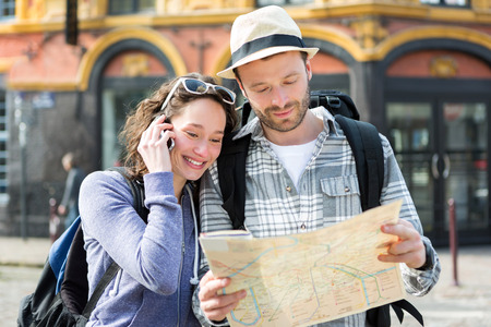 View of a Couple of young attractive tourists watching mapの写真素材