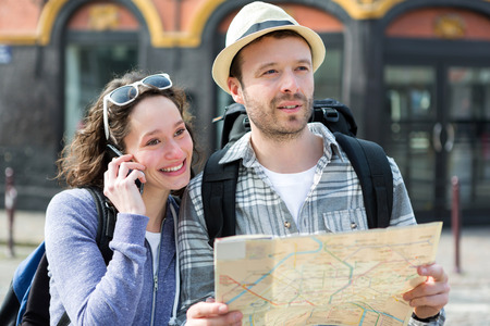View of a Couple of young attractive tourists watching mapの写真素材