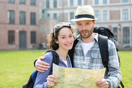 View of a Couple of young attractive tourists watching mapの写真素材
