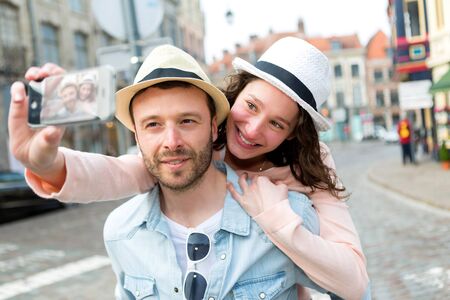 View of a Young couple on holidays taking selfieの写真素材
