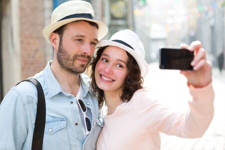 View of a Young couple on holidays taking selfieの写真素材