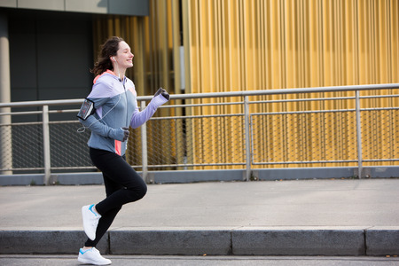 View of a Young attractive woman running downtownの写真素材
