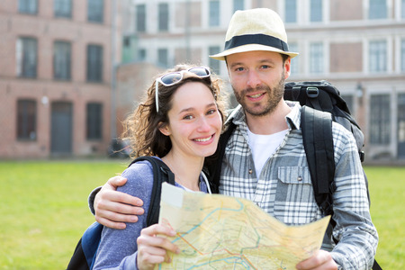 View of a Couple of young attractive tourists watching mapの写真素材
