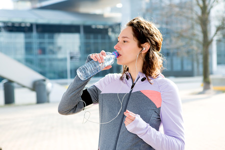 View of a Woman drinking water during a running sessionの写真素材