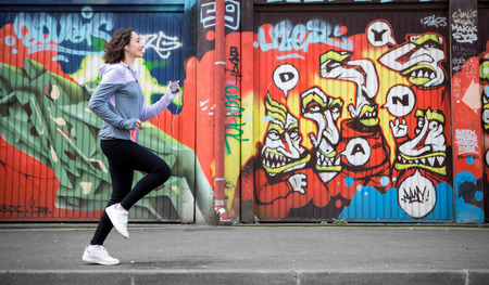 View of a Young attractive woman running downtownの写真素材