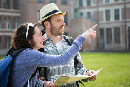 View of a Couple of young attractive tourists watching mapの写真素材