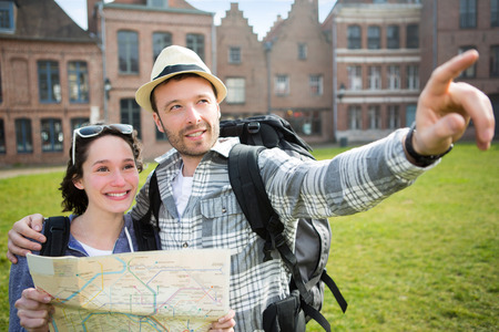 View of a Couple of young attractive tourists watching mapの写真素材