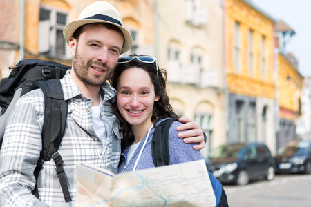View of a Couple of young attractive tourists watching mapの写真素材