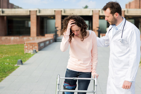 View of a Young doctor assisting a young womanの写真素材