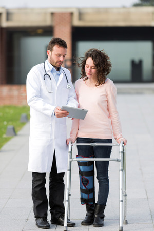 View of a Doctor showing reeducation's tips on tabletの写真素材