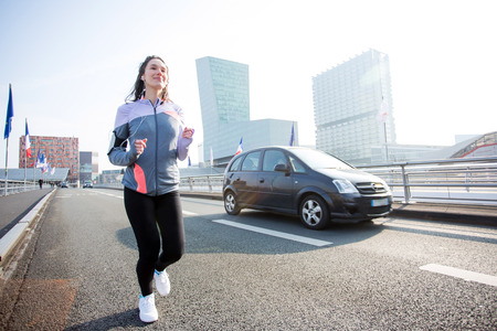 View of a Young attractive woman running downtownの写真素材