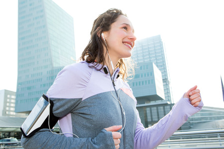 View of a Young attractive woman running downtownの写真素材