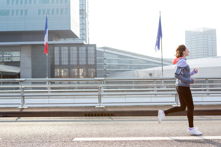 View of a Young attractive woman running downtownの写真素材