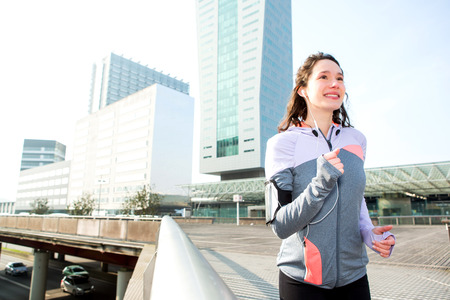 View of a Young attractive woman running downtownの写真素材