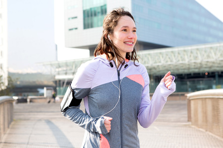 View of a Young attractive woman running downtownの写真素材