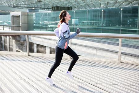 View of a Young attractive woman running downtownの写真素材