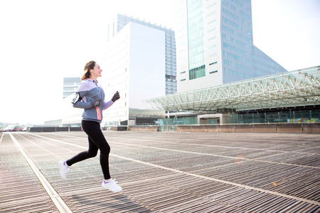 View of a Young attractive woman running downtownの写真素材