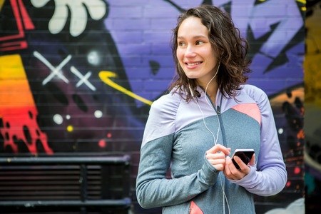 View of a Young attractive woman adjust her music player before runningの写真素材