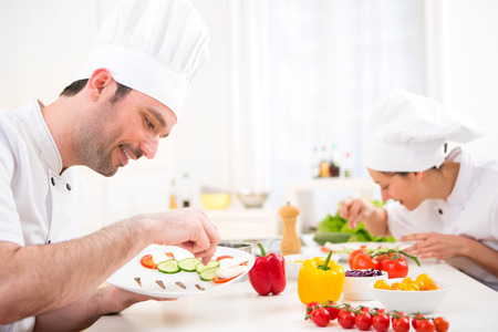View of a Young attractive professional chef cooking in his kitchenの写真素材