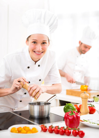 View of a Young attractive professional chef cooking in his kitchenの写真素材