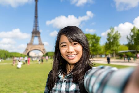 View of a Young attractive asian tourist in Paris taking selfieの写真素材