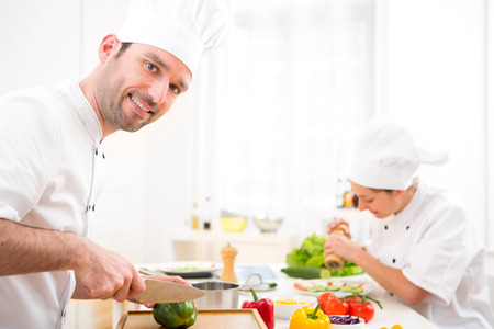 View of a Young attractive professional chef cooking in his kitchenの写真素材