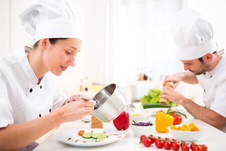 View of a Young attractive professional chef cooking in his kitchenの写真素材