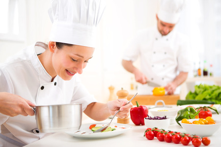 View of a Young attractive professional chef cooking in his kitchenの写真素材