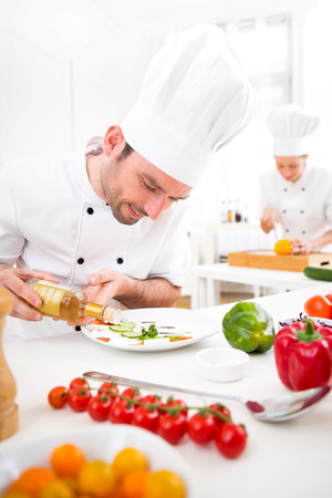 View of a Young attractive professional chef cooking in his kitchenの写真素材
