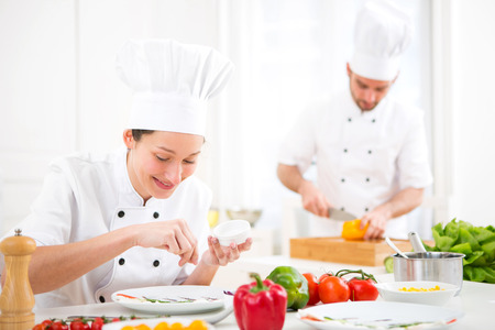View of a Young attractive professional chef cooking in his kitchenの写真素材