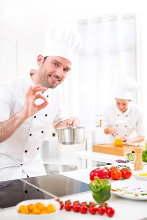 View of a Young attractive professional chef cooking in his kitchenの写真素材