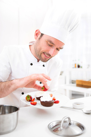 View of a Young attractive professional chef cooking in his kitchenの写真素材