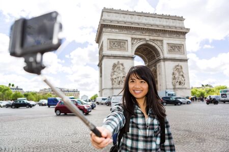 View of a Young attractive asian tourist in Paris taking selfieの写真素材