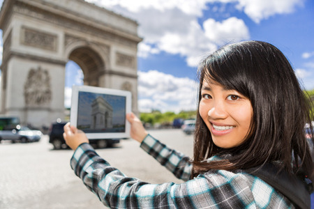 View of a Young attractive asian tourist taking pictures in Parisの写真素材