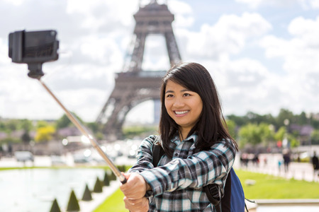 View of a Young attractive asian tourist in Paris taking selfieの写真素材