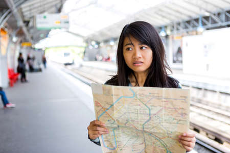 View of a Young attractive asian tourist lost in Parisの写真素材