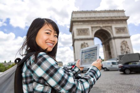 View of a Young attractive asian tourist using tablet in Parisの写真素材
