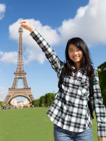View of a Young attractive asian tourist in front of Eiffel towerの写真素材