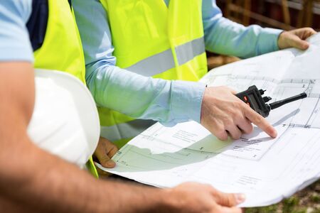 Detailed view of blueprints on a construction siteの写真素材