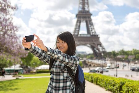 View of a Young attractive asian tourist in Paris taking selfieの写真素材
