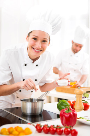 View of a Young attractive professional chef cooking in his kitchenの写真素材